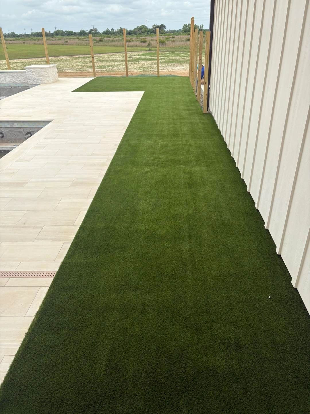 Artificial turf strip along side of house