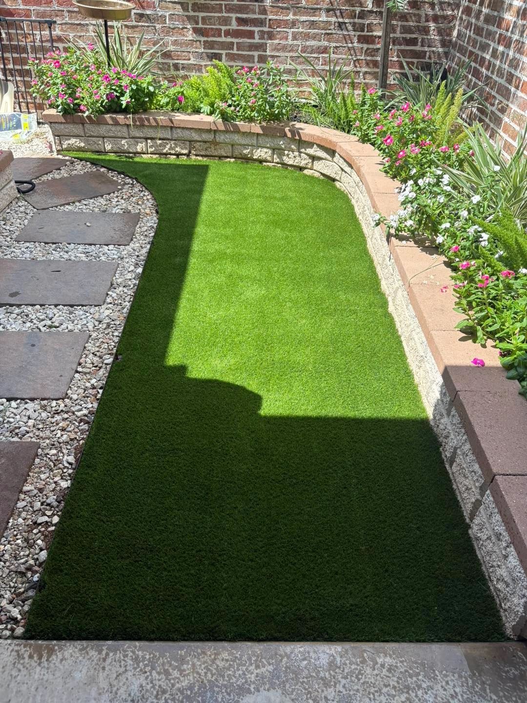 Artificial turf garden strip with flower bed border
