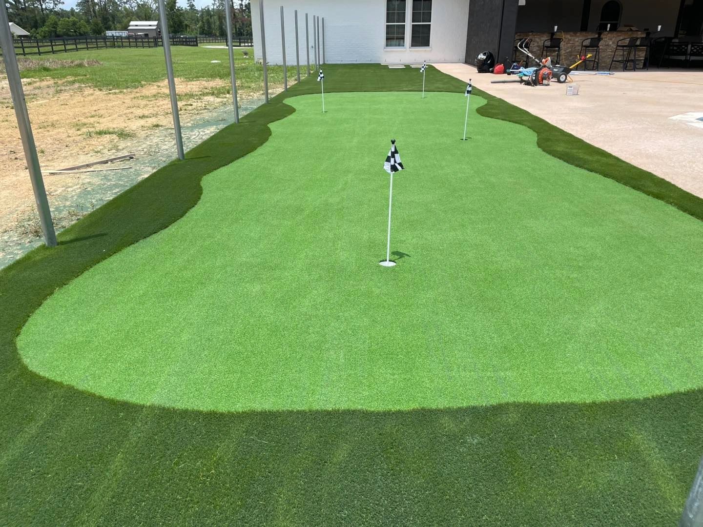 Large residential practice putting green with multiple holes